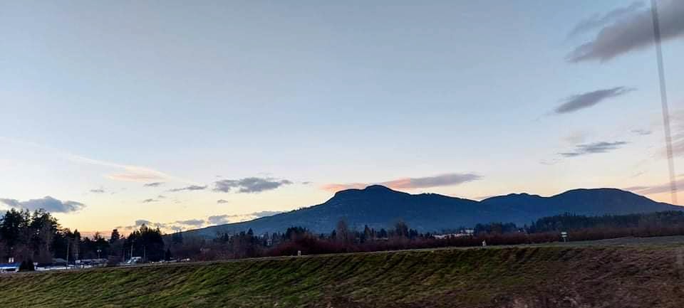 A wide scenic view of Mount Prevost at sunset in the Cowichan Valley, serving as the header for local marketing advice.